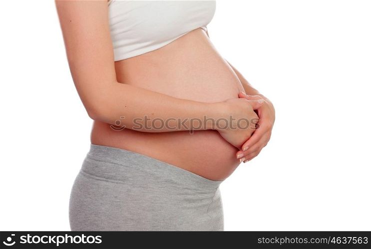 Pregnant woman stroking her belly isolated on a white background