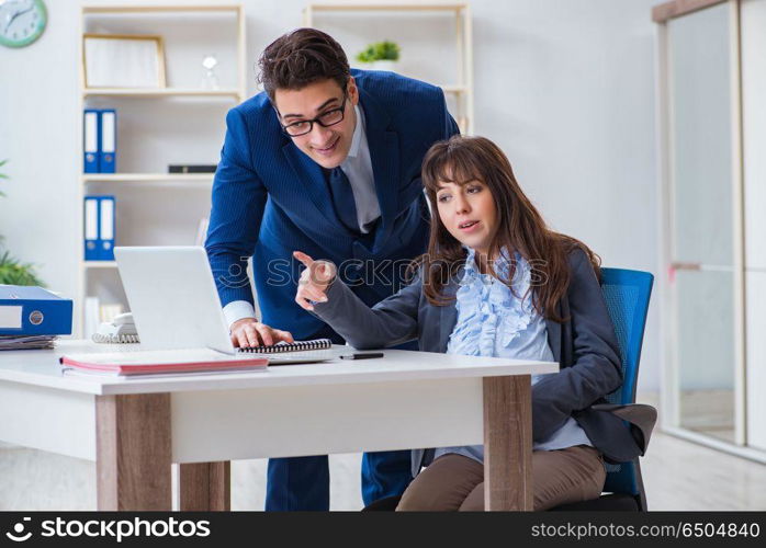 Pregnant woman struggling in the office and getting colleague he. Pregnant woman struggling in the office and getting colleague help. Pregnant woman struggling in the office and getting colleague he