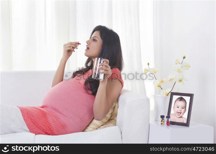 Pregnant woman taking medicine