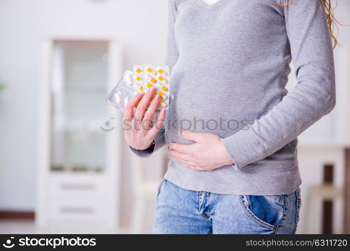 Pregnant woman taking pills during pregnancy