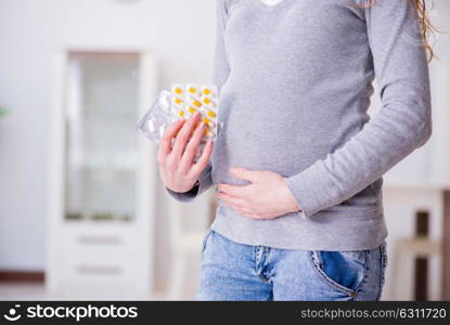 Pregnant woman taking pills during pregnancy