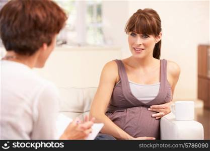 Pregnant woman talking to midwife