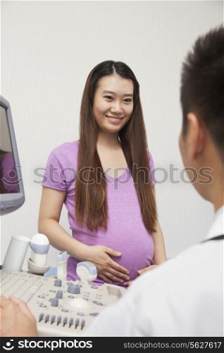 Pregnant Woman Talking With Doctor
