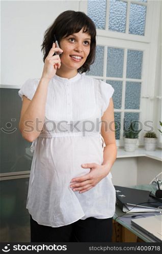 Pregnant woman using a cell phone