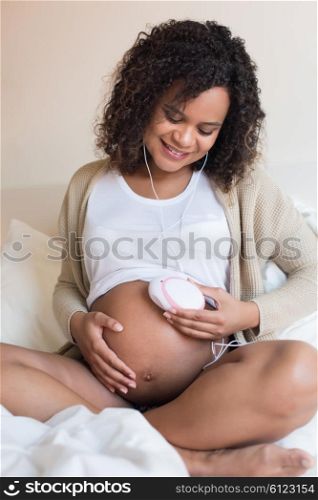Pregnant woman using a fetal doppler at home