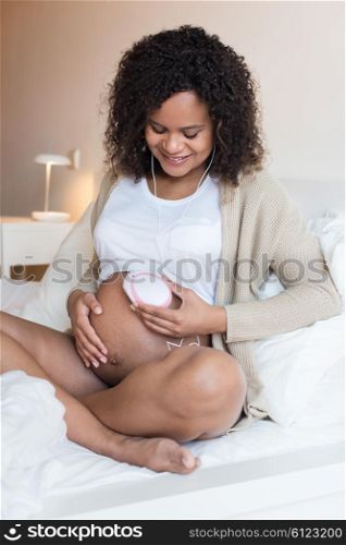 Pregnant woman using a fetal doppler at home