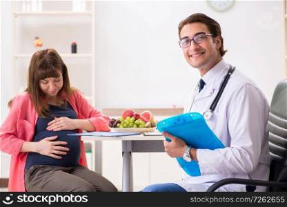 Pregnant woman visiting doctor discussing healthy diet. The pregnant woman visiting doctor discussing healthy diet