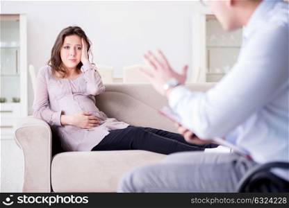 Pregnant woman visiting psychologist doctor. The pregnant woman visiting psychologist doctor