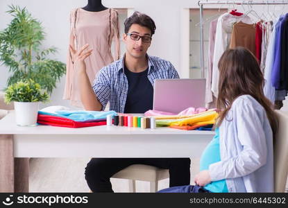 Pregnant woman visiting tailor for new clothing