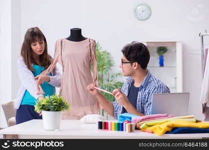 Pregnant woman visiting tailor for new clothing