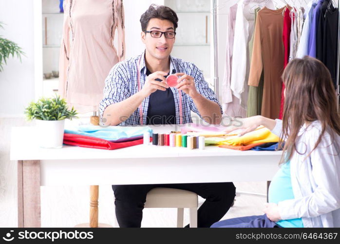 Pregnant woman visiting tailor for new clothing