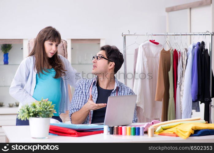 Pregnant woman visiting tailor for new clothing