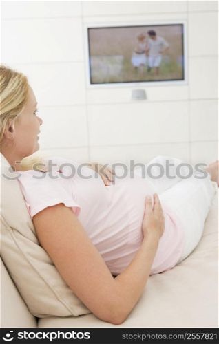 Pregnant woman watching television
