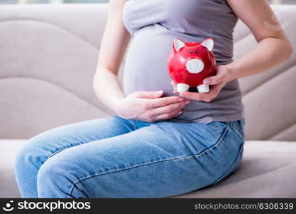 Pregnant woman with a belly tummy sitting on a sofa at home