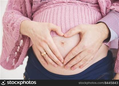pregnant woman with a heart at the stomach