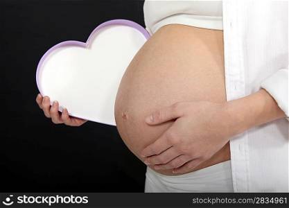 Pregnant woman with a heart shaped box