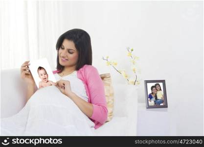 Pregnant woman with a picture of her baby