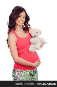 Pregnant woman with a teddy isolated on a white background