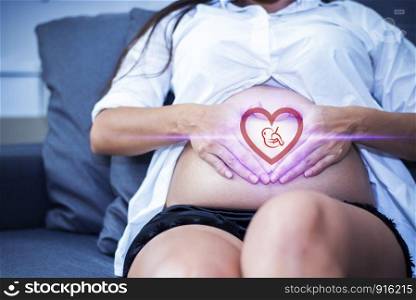 Pregnant woman with baby illustration in heart shape, Newborn and family concept. Healthcare theme