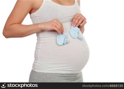 Pregnant woman with booties for her baby isolated on a white background