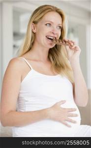 Pregnant woman with chocolate smiling