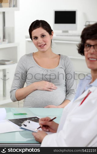 Pregnant woman with doctor