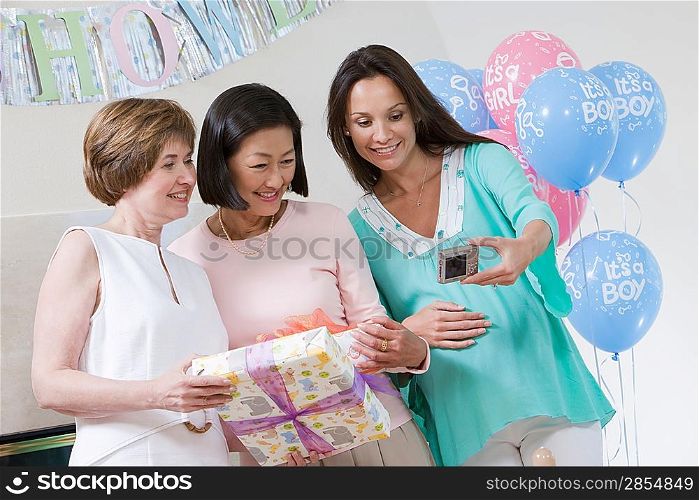 Pregnant Woman with Friends at a Baby Shower Taking Photos