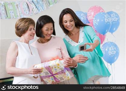 Pregnant Woman with Friends at a Baby Shower Taking Photos