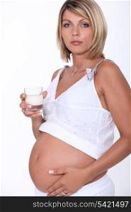 Pregnant woman with glass of milk