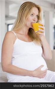 Pregnant woman with glass of orange juice
