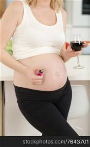 pregnant woman with glass of wine and cigarette