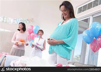 Pregnant Woman with Hands on Her Stomach at baby shower