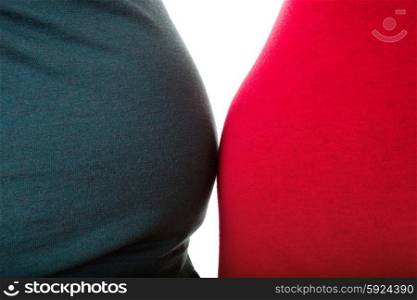 Pregnant woman with her husband, close up on the belly