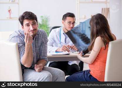 Pregnant woman with her husband visiting the doctor in clinic