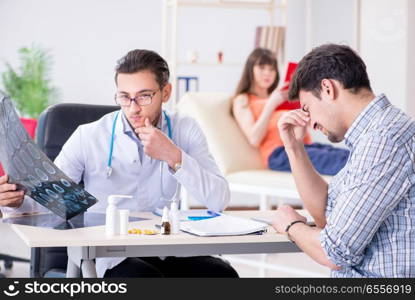 Pregnant woman with her husband visiting the doctor in clinic