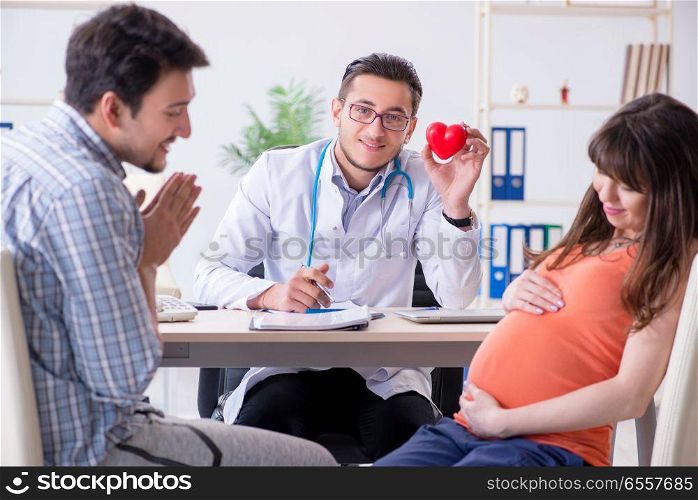 Pregnant woman with her husband visiting the doctor in clinic