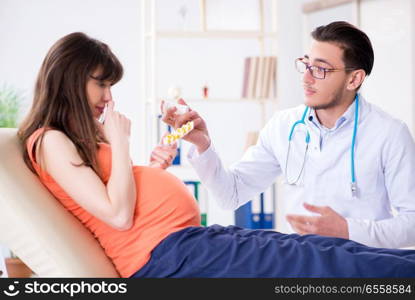 Pregnant woman with her husband visiting the doctor in clinic