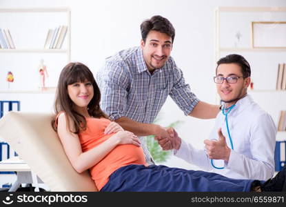 Pregnant woman with her husband visiting the doctor in clinic