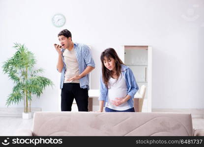 Pregnant woman with husband at home