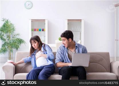 Pregnant woman with husband at home