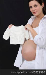 Pregnant woman with knitted jumper