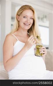 Pregnant woman with pickles smiling