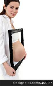 Pregnant woman with picture frame