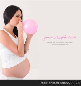 pregnant woman with pink balloon