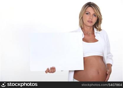 Pregnant woman with white poster