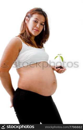 Pregnant woman with young plant in hand dressed in white and black, isolated