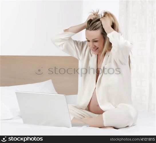 Pregnant woman working on a laptop