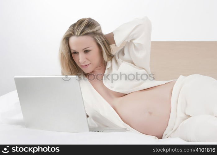 Pregnant woman working on a laptop