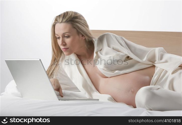 Pregnant woman working on a laptop