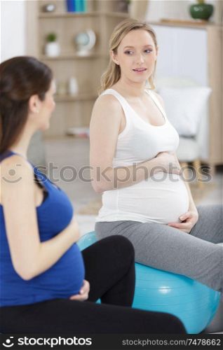 pregnant women doing relax exercises with a fitball